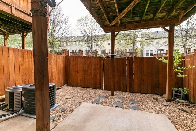 a backyard of a house with barbeque oven table and chairs