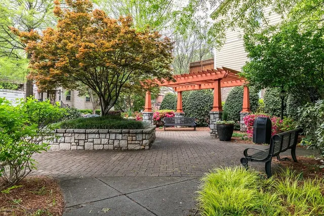 a view of a table and chairs in back yard of the house