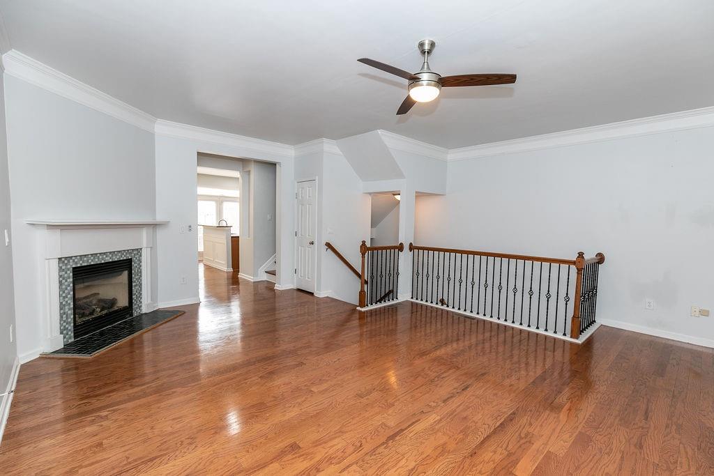 827 Charles Bank Avenue Southeast, Unit 827 Atlanta, GA 30312 - Photo 5 of 45 a view of an empty room with wooden floor a fireplace and a window