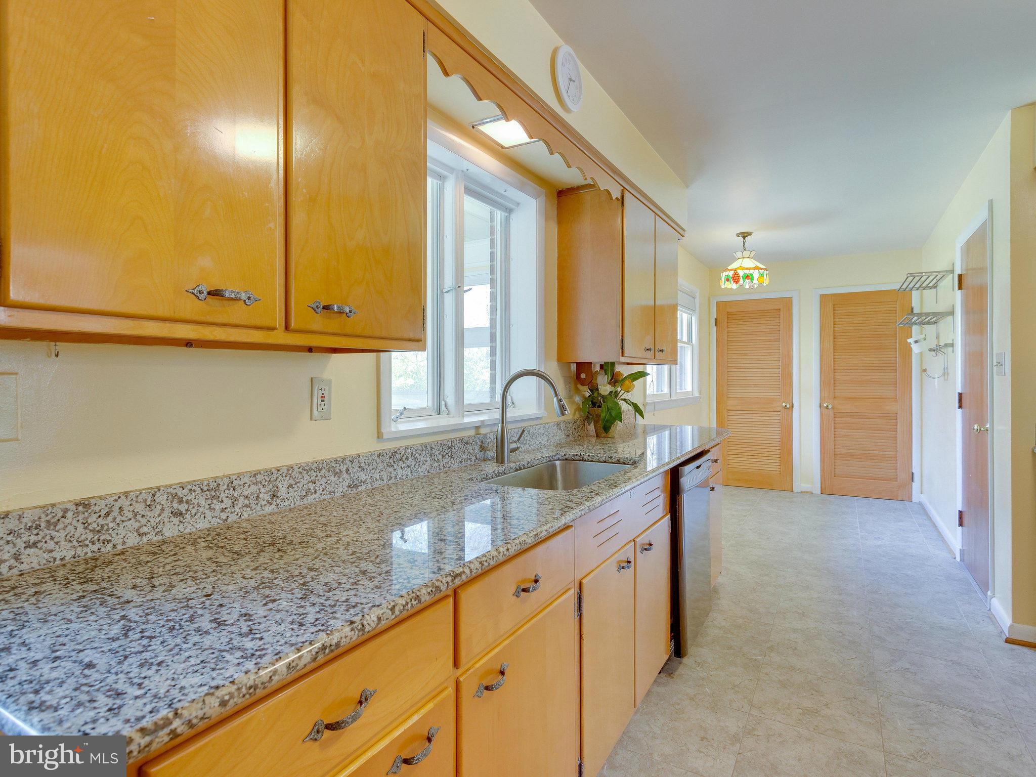 6714 Greenleaf Street Springfield, VA 22150 - Photo 11 of 30 a kitchen with granite countertop a sink and cabinets