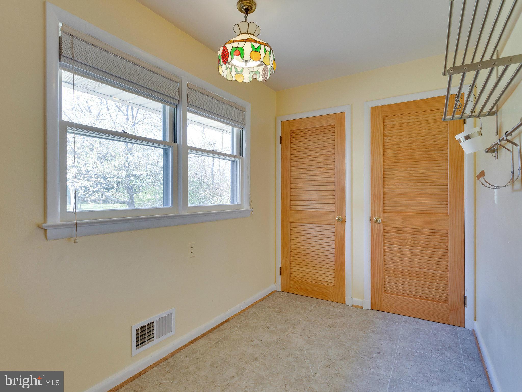 6714 Greenleaf Street Springfield, VA 22150 - Photo 12 of 30 an empty room with windows and chandelier