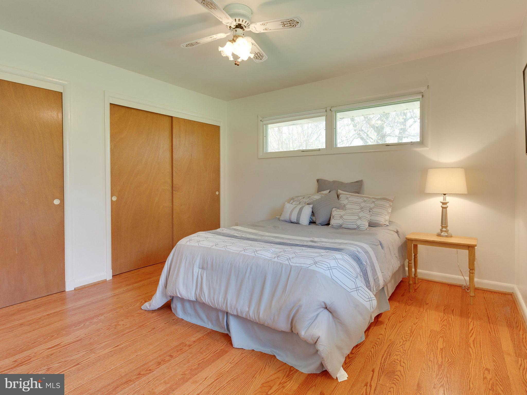 6714 Greenleaf Street Springfield, VA 22150 - Photo 16 of 30 a bedroom with a bed and a lamp