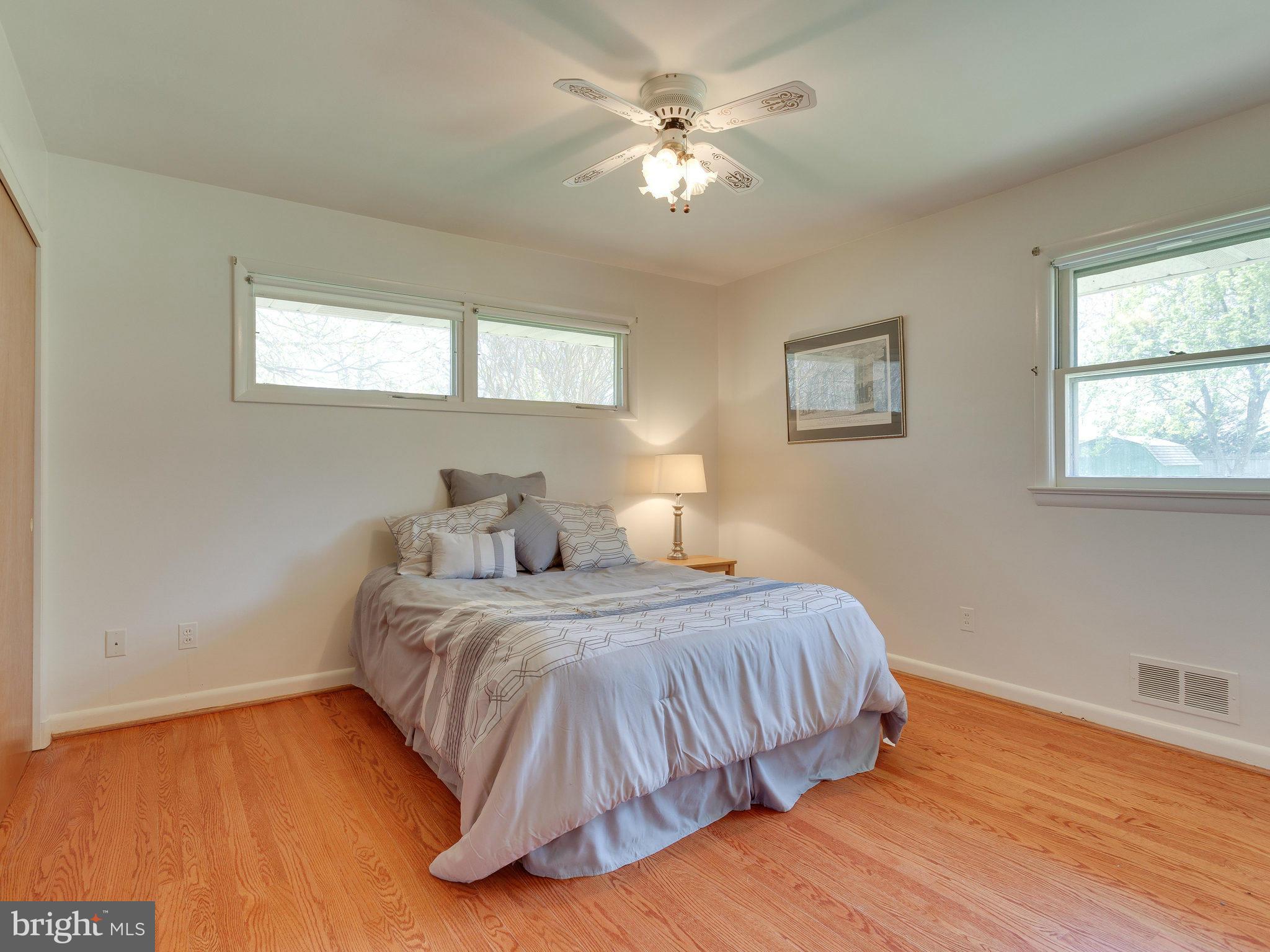 6714 Greenleaf Street Springfield, VA 22150 - Photo 17 of 30 a bedroom with a bed chandelier and a window