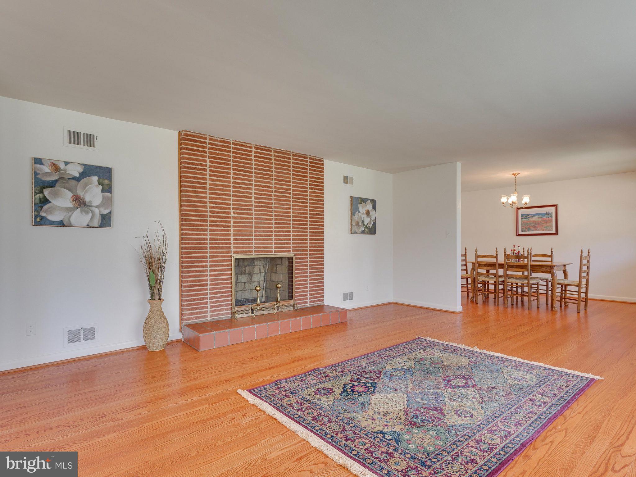 6714 Greenleaf Street Springfield, VA 22150 - Photo 3 of 30 an empty room with furniture and a fireplace