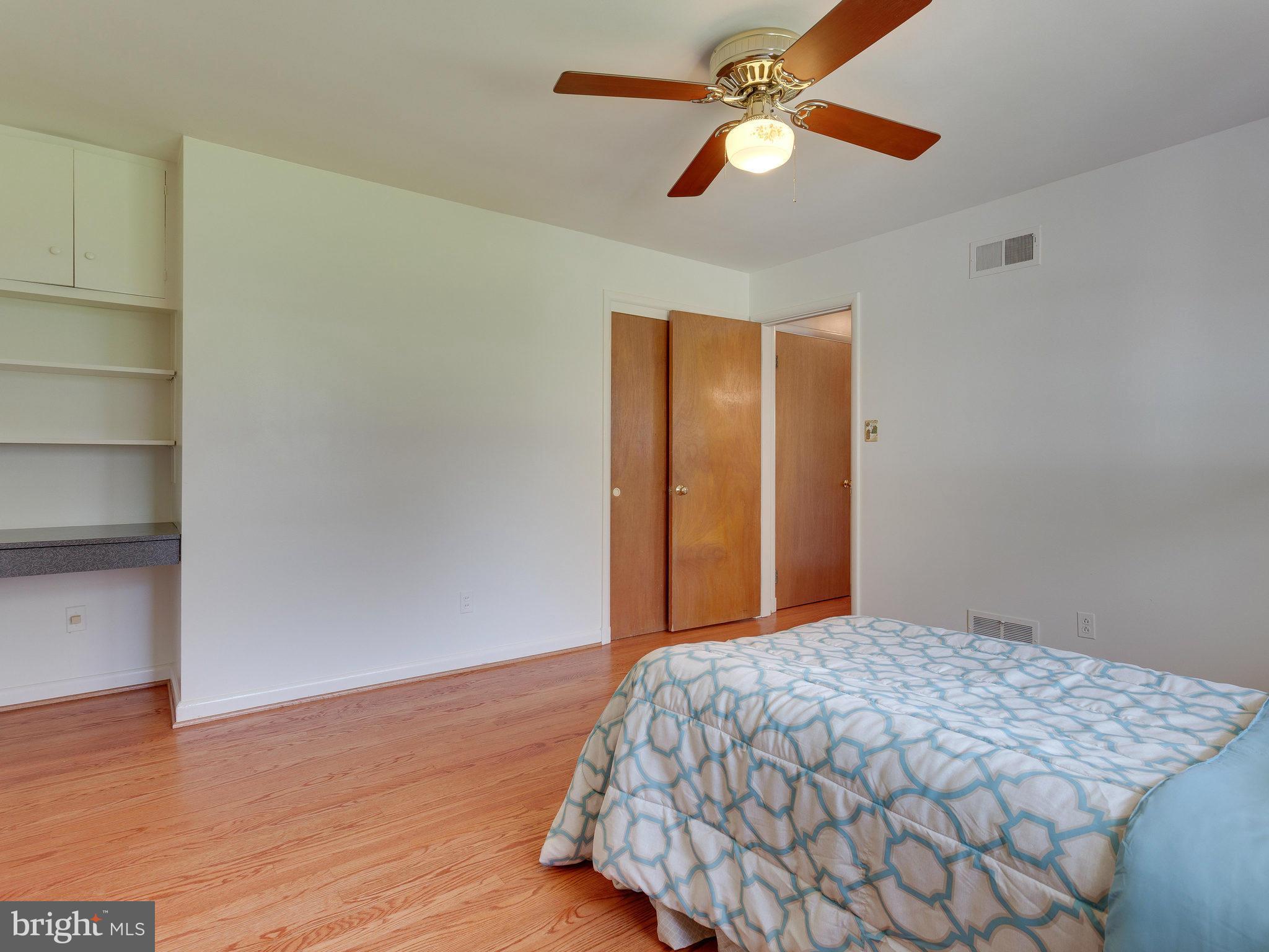 6714 Greenleaf Street Springfield, VA 22150 - Photo 26 of 30 a bedroom with a bed and a chandelier