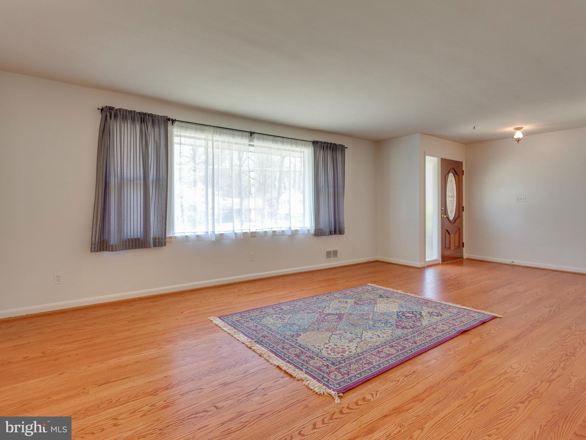 6714 Greenleaf Street Springfield, VA 22150 - Photo 5 of 30 an empty room with wooden floor and windows