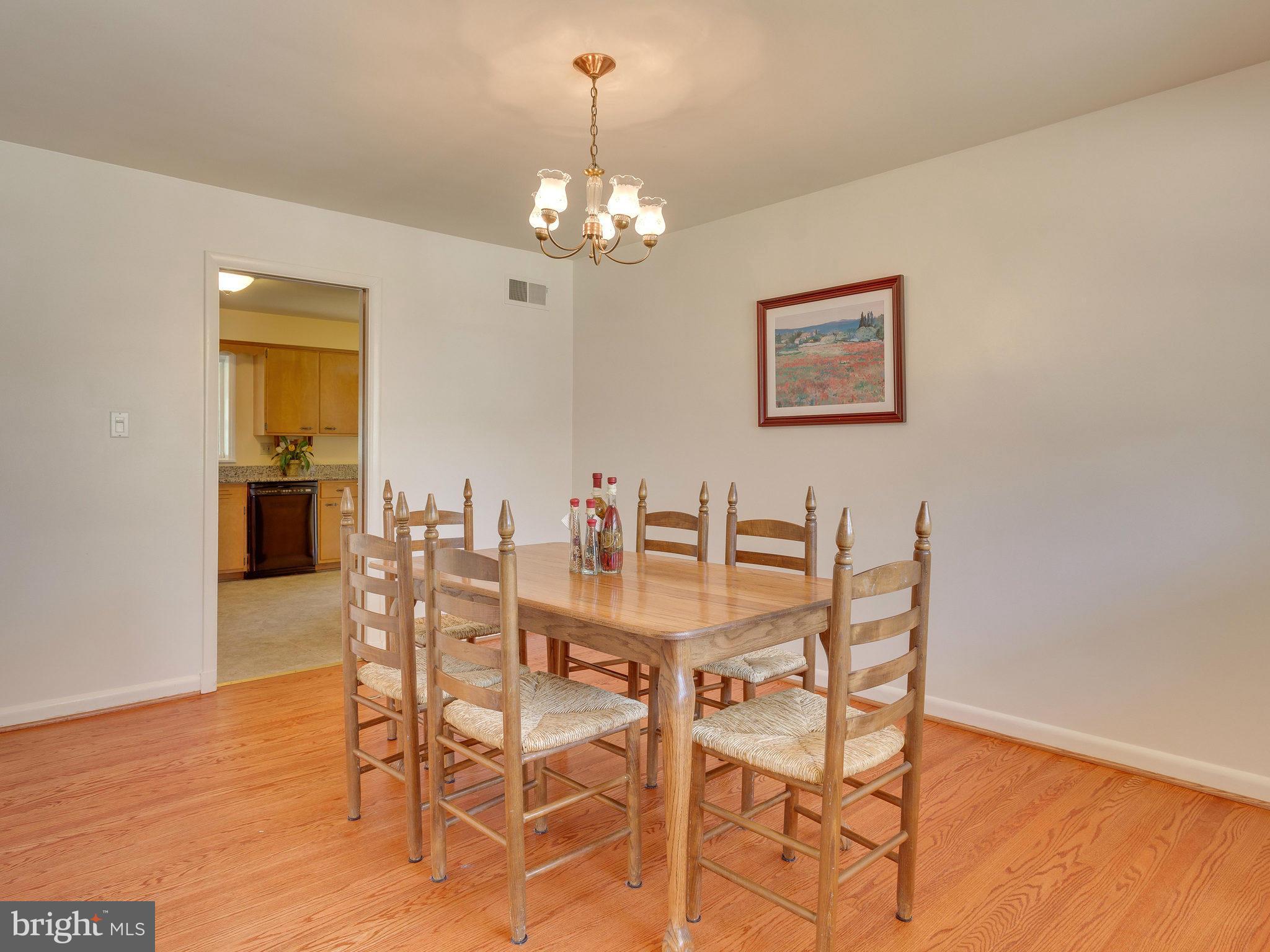 6714 Greenleaf Street Springfield, VA 22150 - Photo 6 of 30 a view of a dining room with furniture and chandelier
