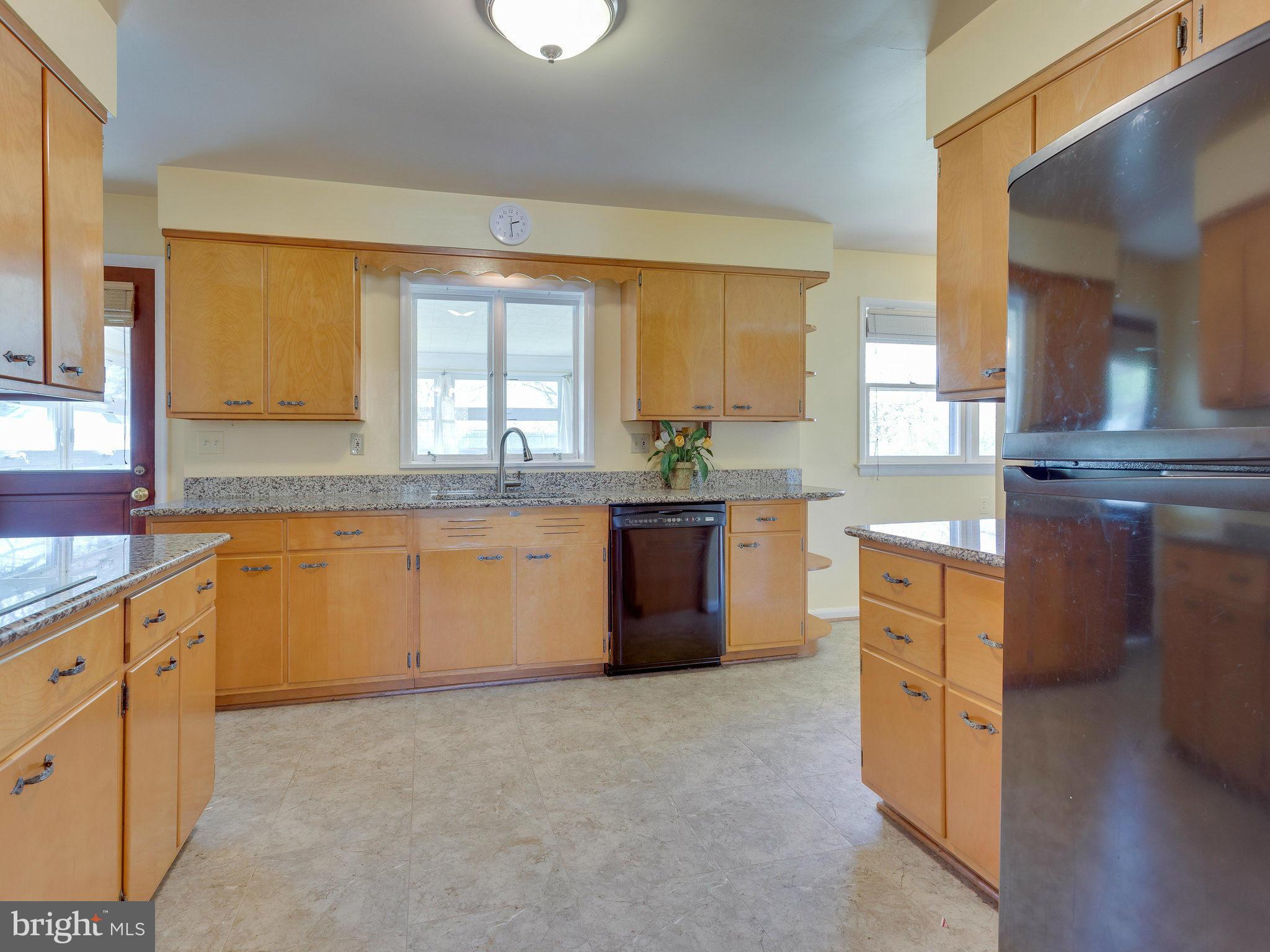 6714 Greenleaf Street Springfield, VA 22150 - Photo 7 of 30 a kitchen with granite countertop a stove sink and cabinets