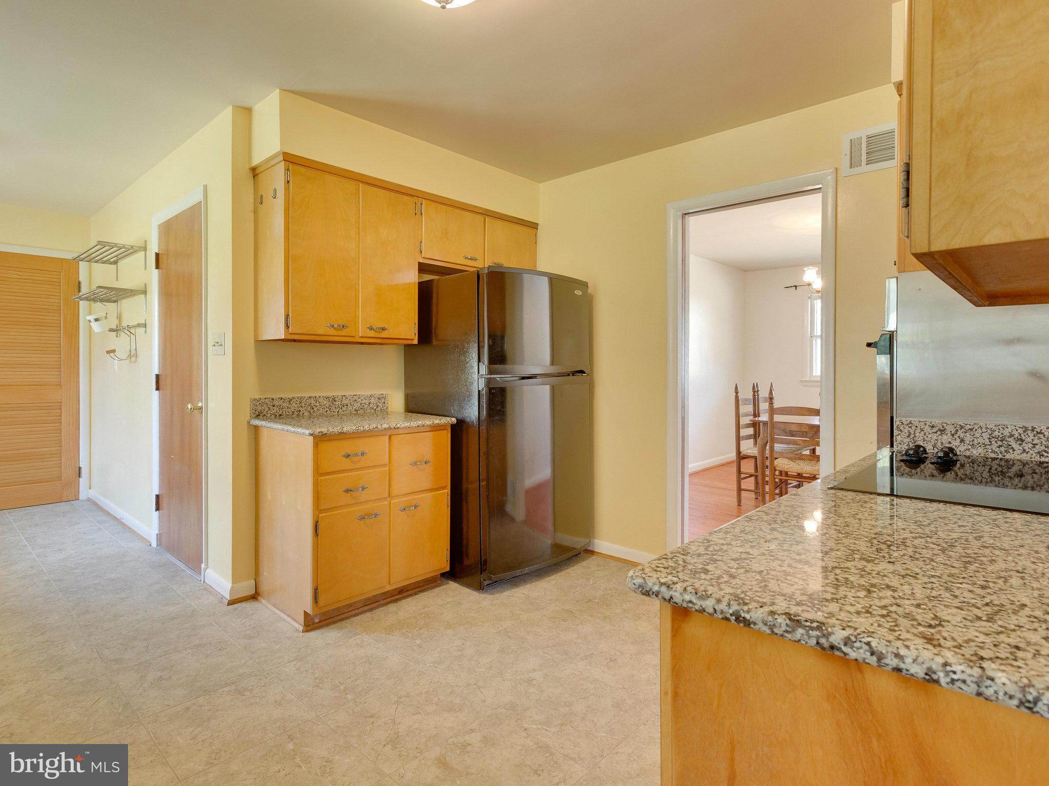 6714 Greenleaf Street Springfield, VA 22150 - Photo 8 of 30 a kitchen with stainless steel appliances granite countertop a refrigerator and a sink