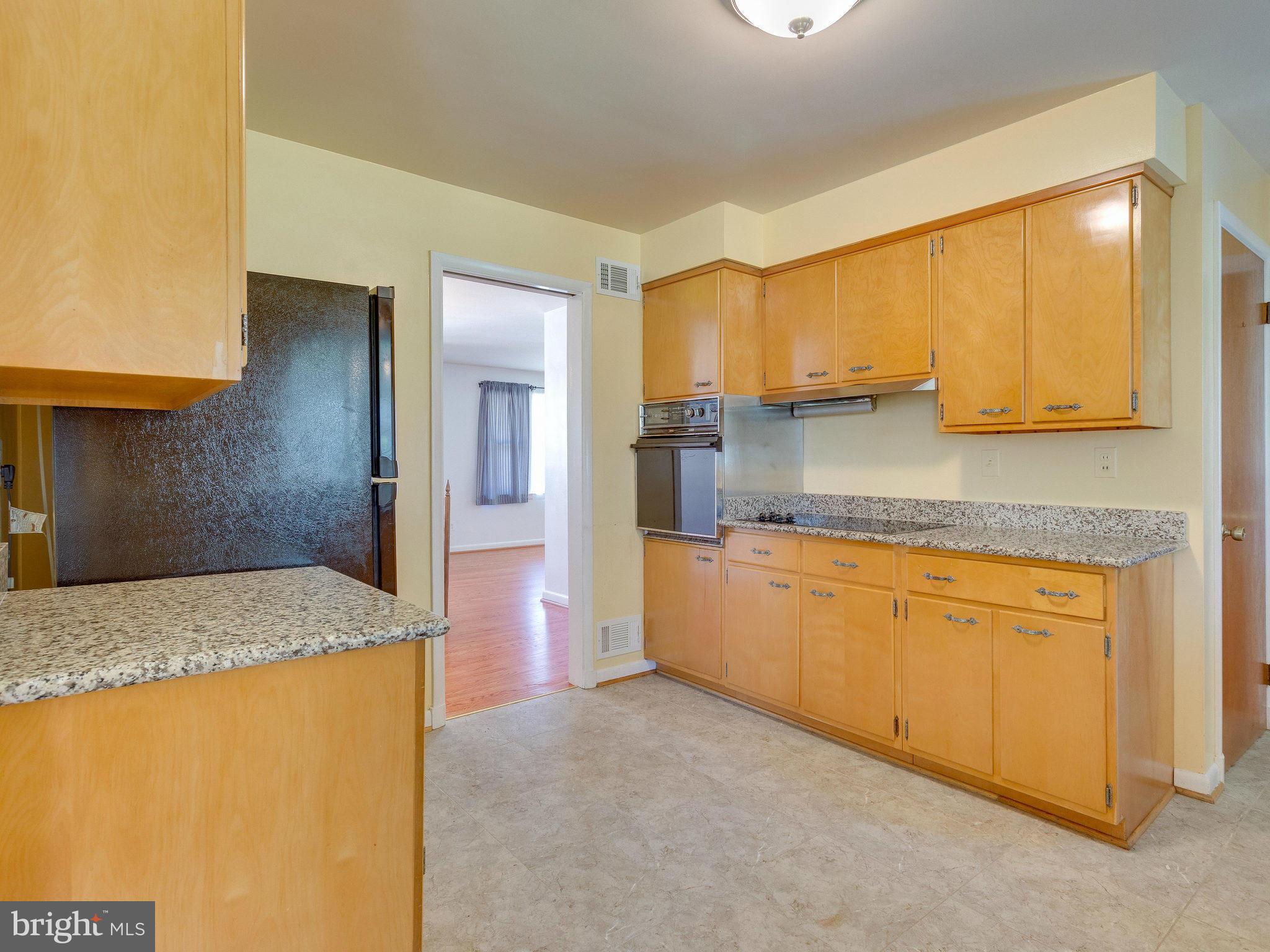 6714 Greenleaf Street Springfield, VA 22150 - Photo 9 of 30 a kitchen with stainless steel appliances granite countertop refrigerator sink and cabinets