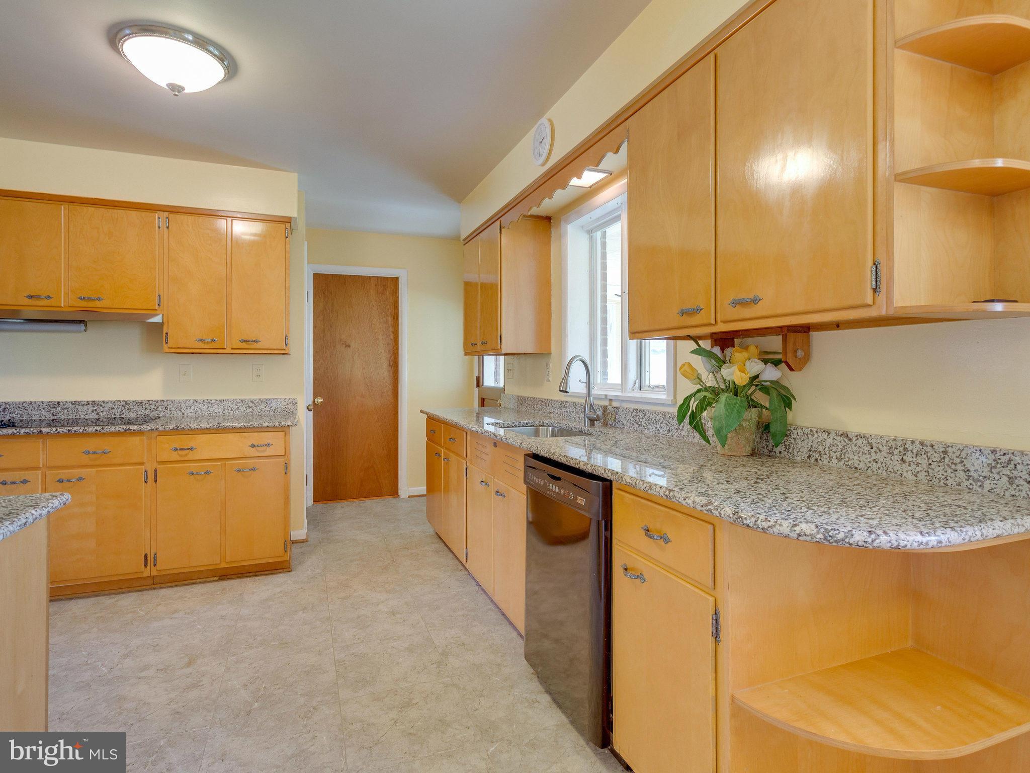 6714 Greenleaf Street Springfield, VA 22150 - Photo 10 of 30 a kitchen with stainless steel appliances granite countertop a sink and a stove