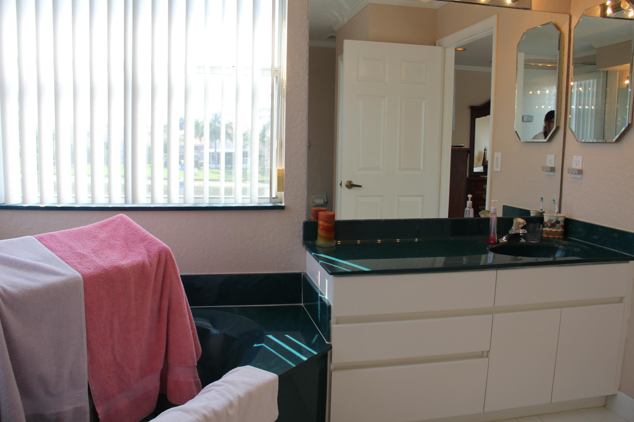 7354 Michigan Isle Road Lake Worth, FL 33467 - Photo 15 of 21 a bathroom with a sink and a mirror