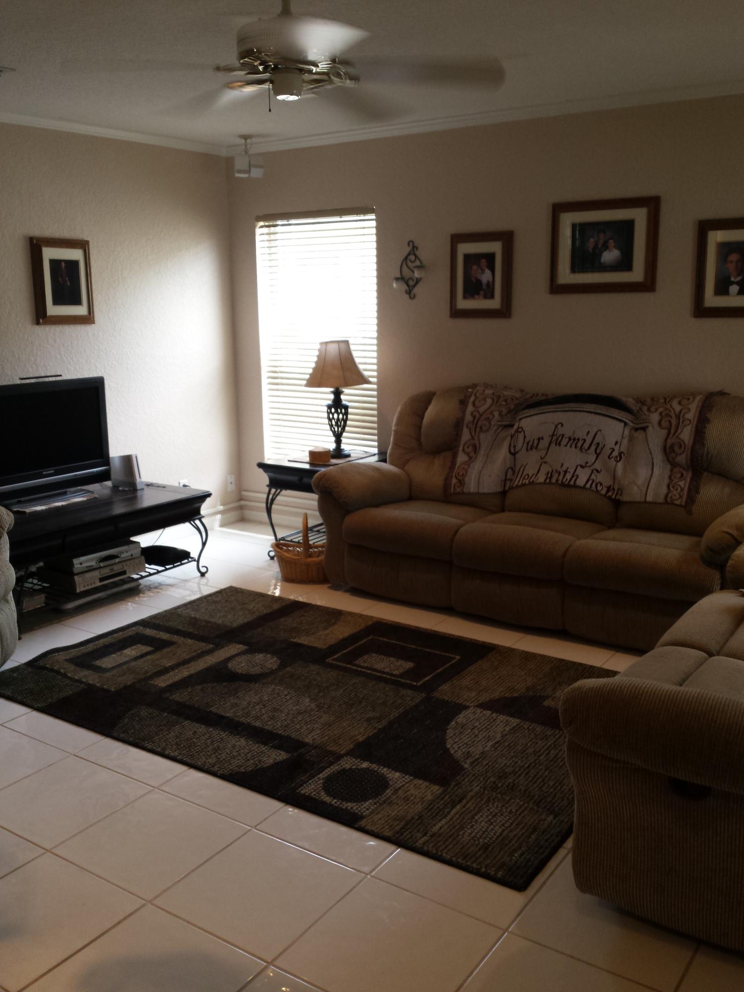 7354 Michigan Isle Road Lake Worth, FL 33467 - Photo 20 of 21 a living room with furniture and a flat screen tv