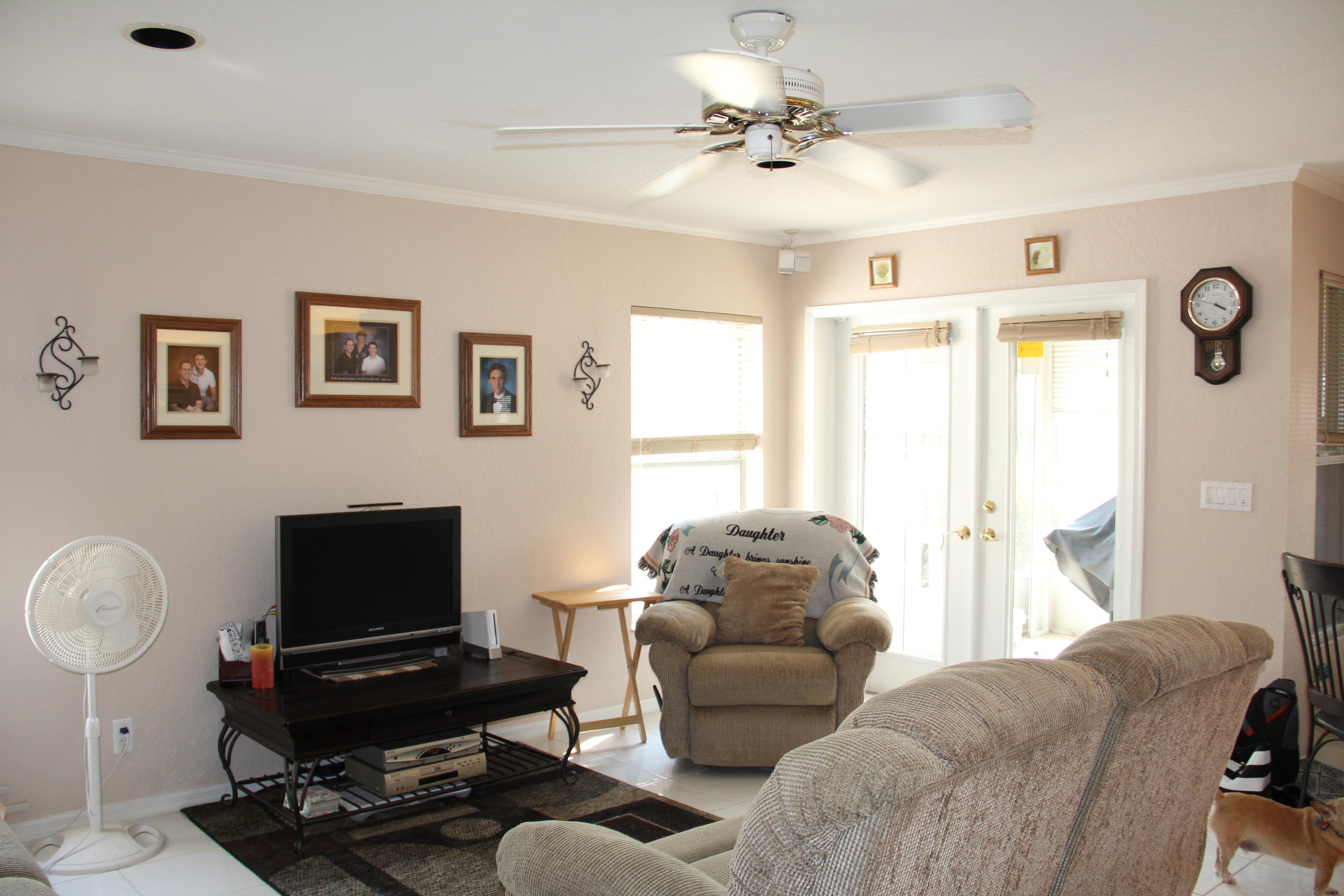 7354 Michigan Isle Road Lake Worth, FL 33467 - Photo 6 of 21 a living room with furniture ceiling fan and a window