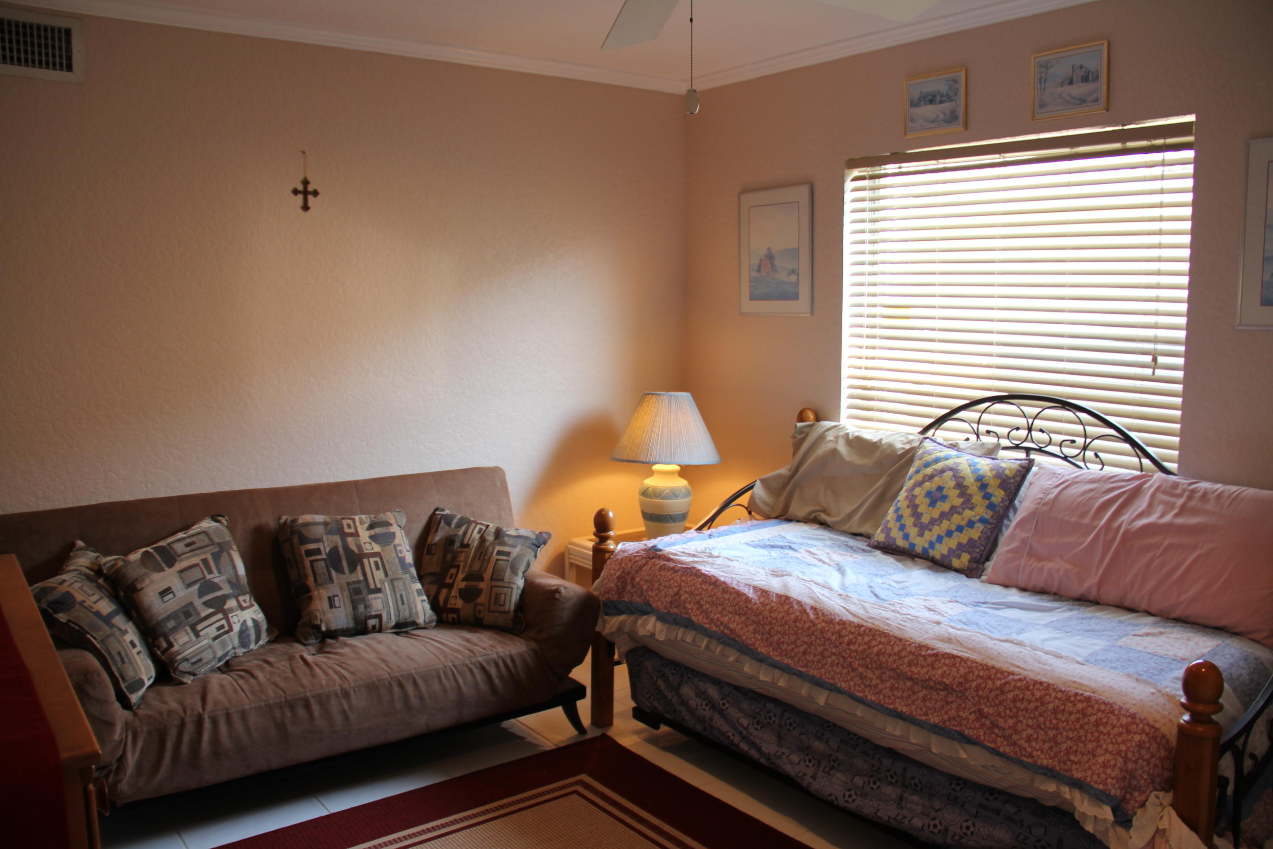 7354 Michigan Isle Road Lake Worth, FL 33467 - Photo 8 of 21 a bedroom with a bed couch and window
