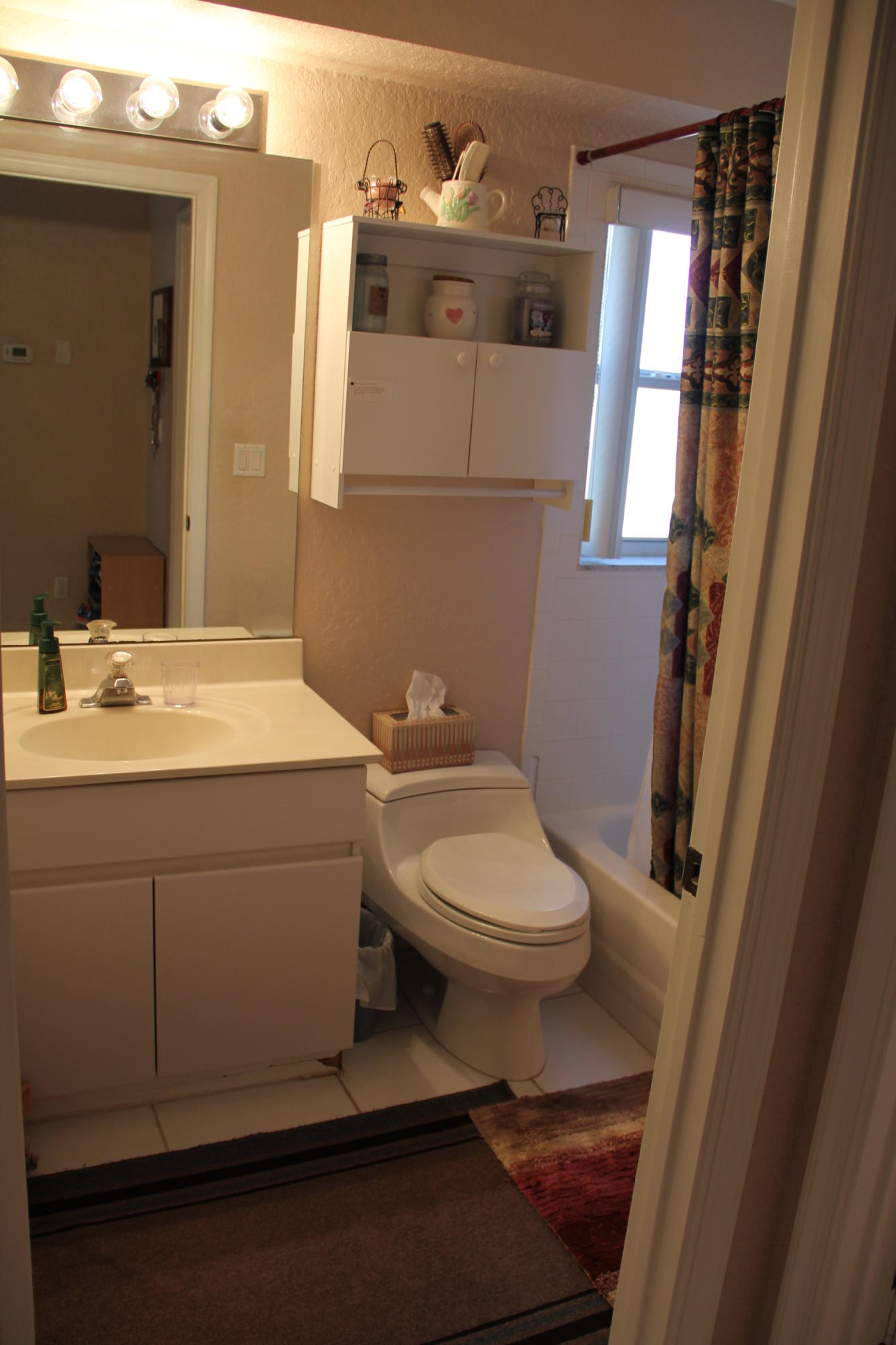 7354 Michigan Isle Road Lake Worth, FL 33467 - Photo 9 of 21 a bathroom with a toilet sink and mirror