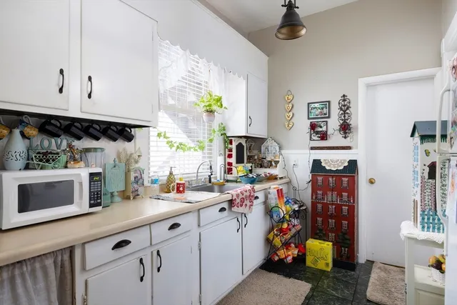 a kitchen with a sink cabinets and window