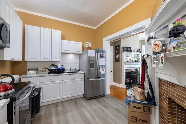 a kitchen with stainless steel appliances granite countertop a refrigerator stove and sink