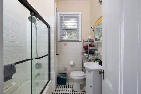 a bathroom with a toilet a sink and a shower