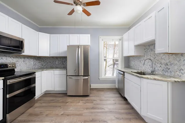 a kitchen with a refrigerator sink and microwave