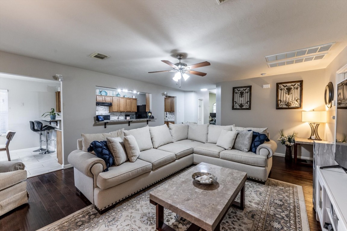 13507 Beech Ridge Lane Houston, TX 77083 - Photo 11 of 49 a living room with furniture and a chandelier