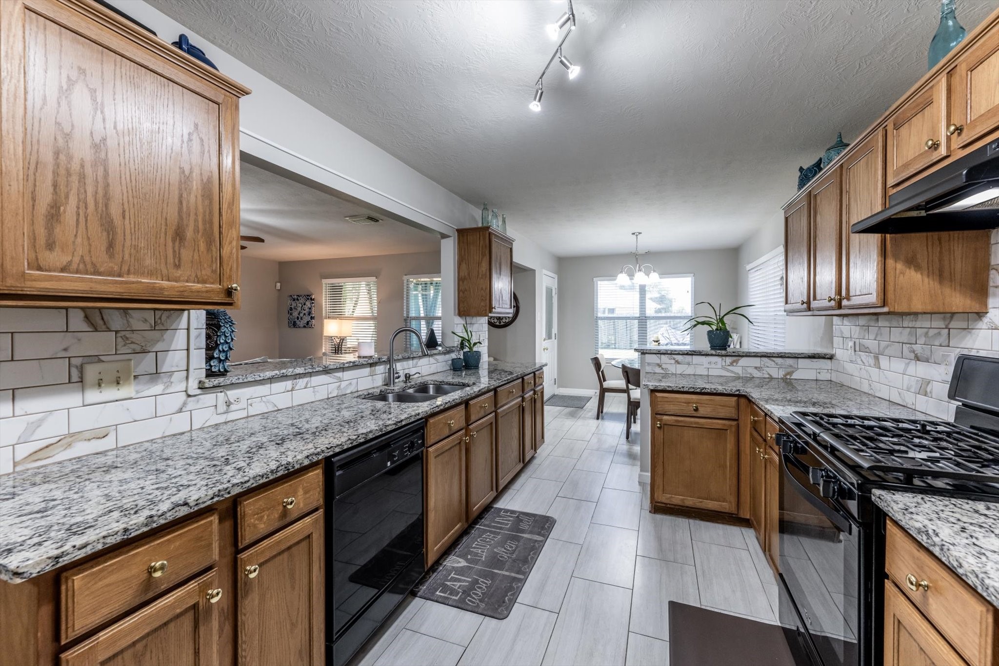 13507 Beech Ridge Lane Houston, TX 77083 - Photo 12 of 49 a large kitchen with granite countertop lots of counter top space a sink and stainless steel appliances