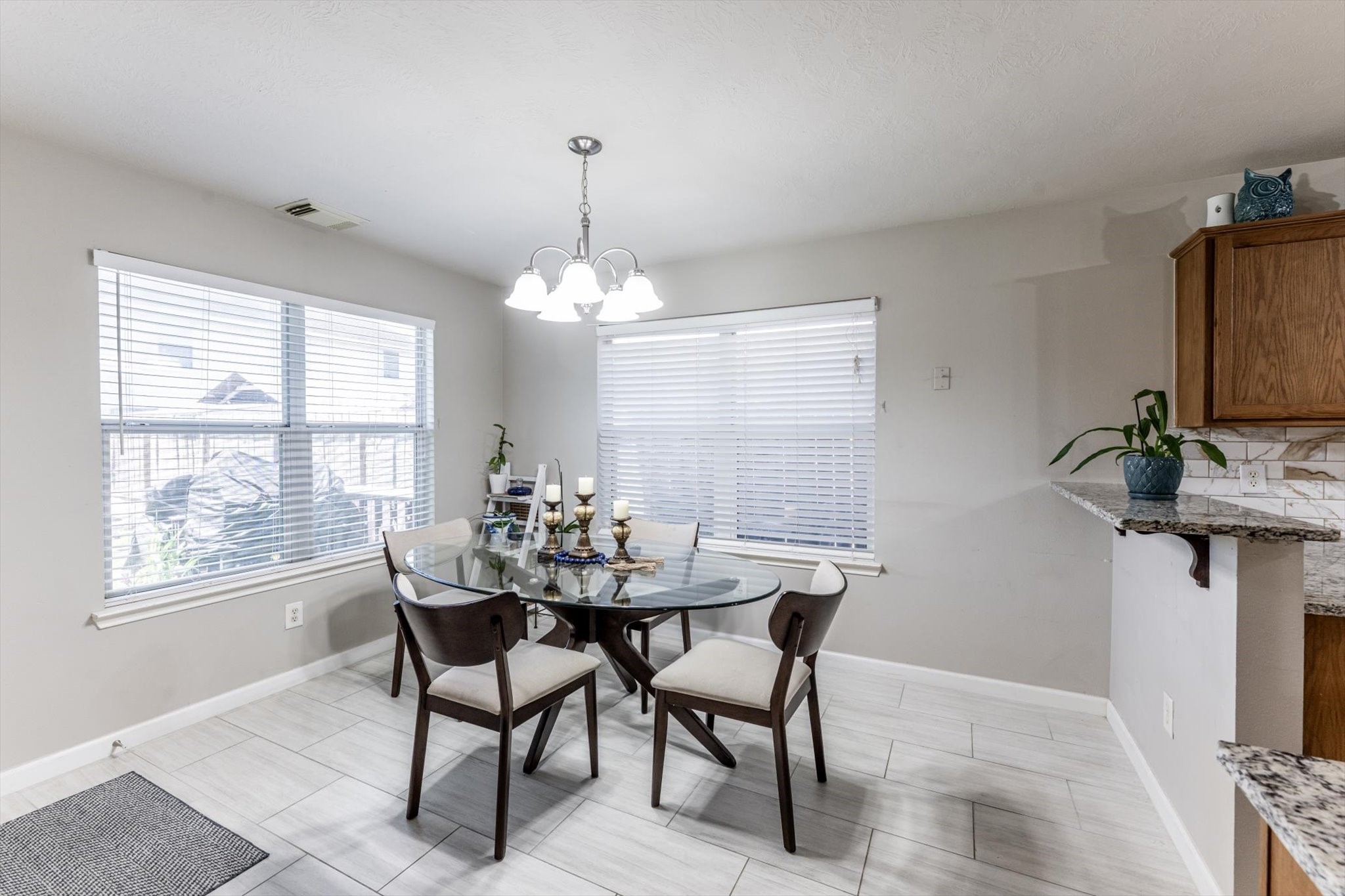 13507 Beech Ridge Lane Houston, TX 77083 - Photo 20 of 49 a view of a dining room with furniture and chandelier