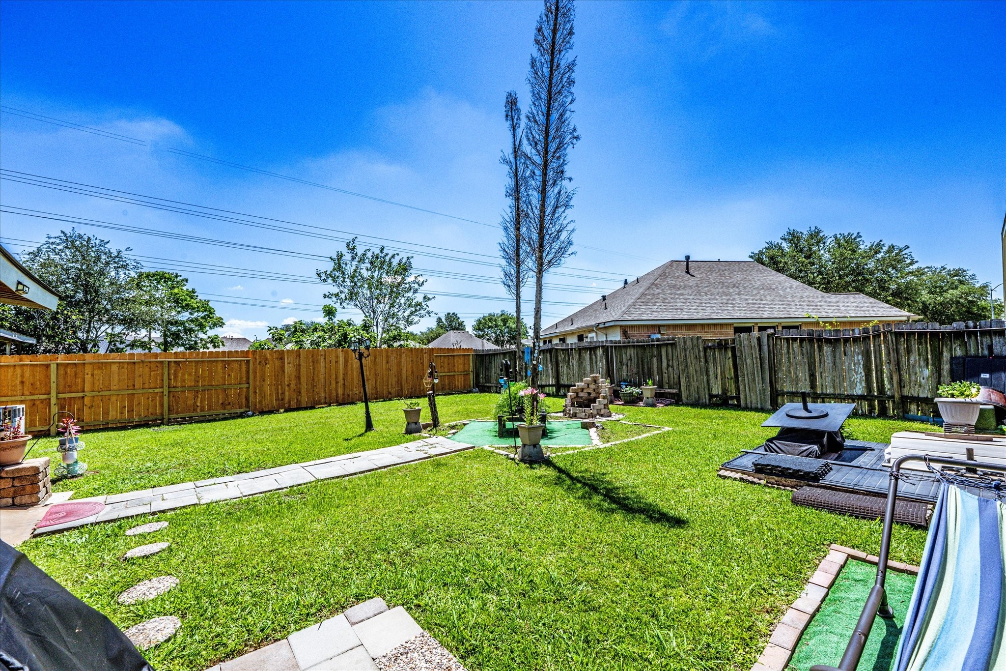 13507 Beech Ridge Lane Houston, TX 77083 - Photo 2 of 49 a view of a table and chairs under an umbrella in the backyard