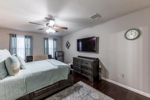 a bedroom with a bed and a chandelier