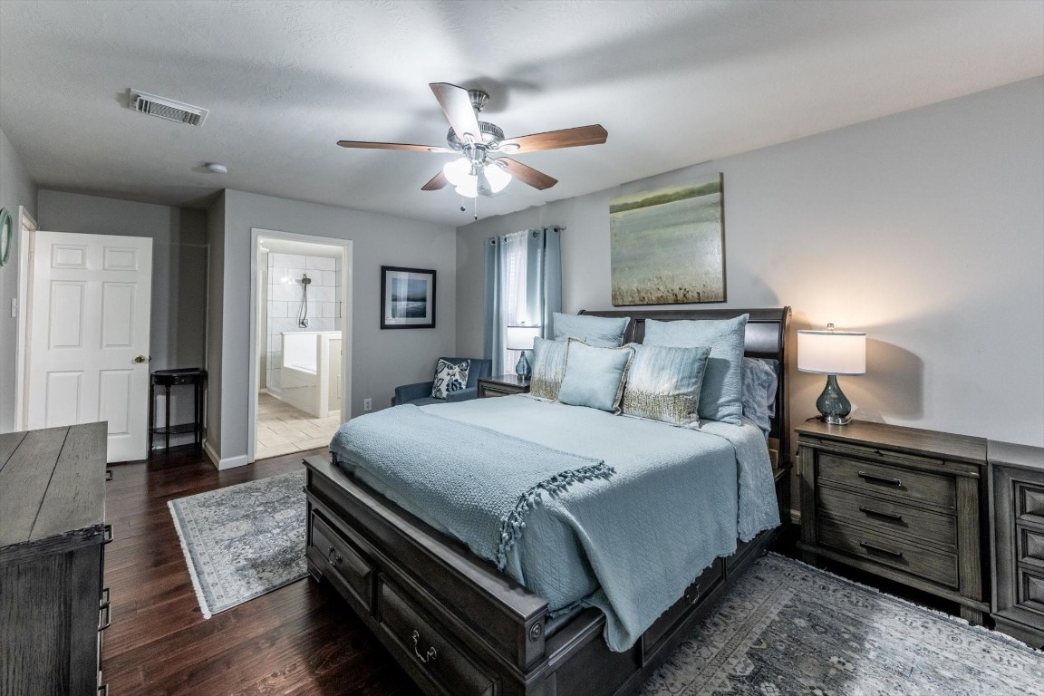 13507 Beech Ridge Lane Houston, TX 77083 - Photo 25 of 49 a bedroom with a bed and a chandelier