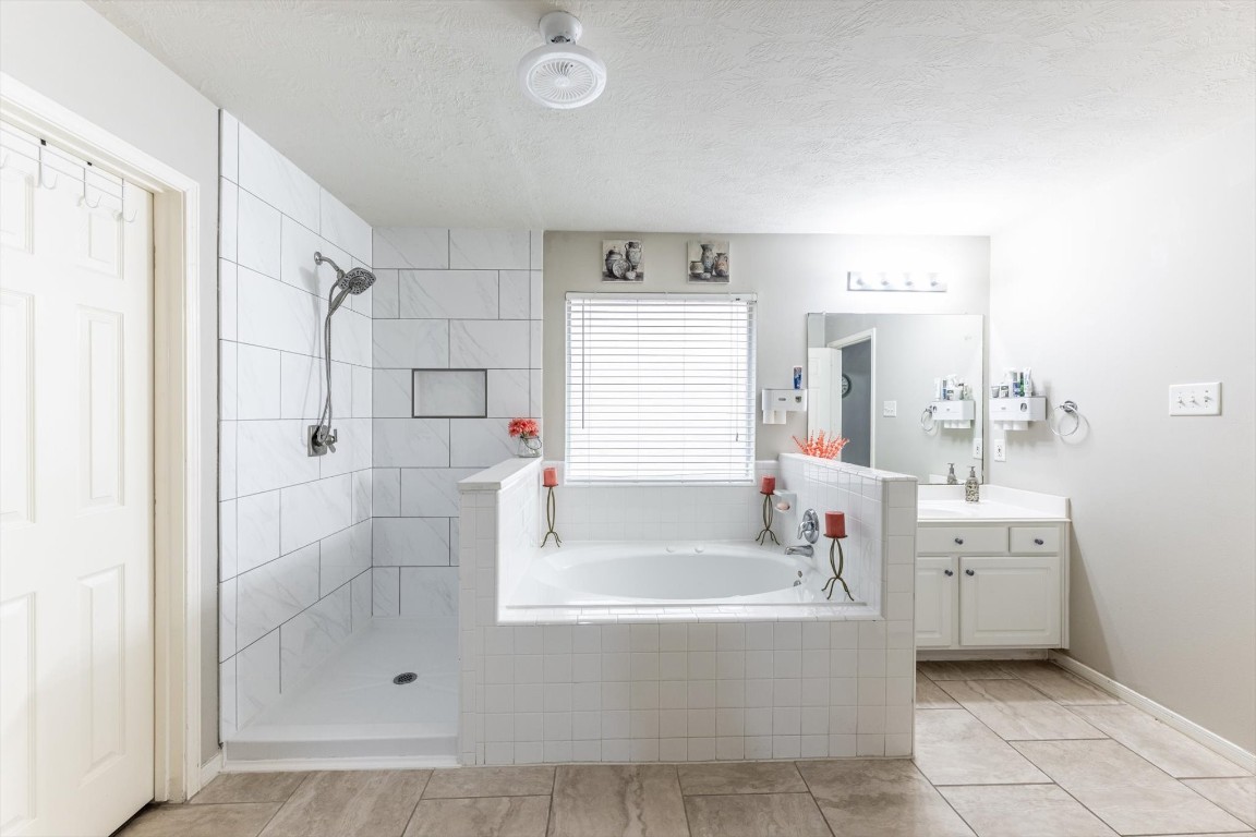 13507 Beech Ridge Lane Houston, TX 77083 - Photo 28 of 49 a white bath tub sitting next to a bathroom sink