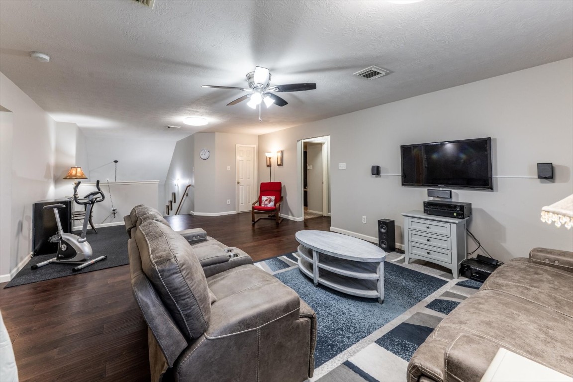 13507 Beech Ridge Lane Houston, TX 77083 - Photo 31 of 49 a living room with furniture and a flat screen tv