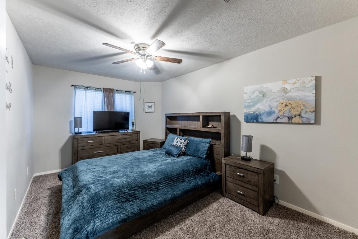 13507 Beech Ridge Lane Houston, TX 77083 - Photo 40 of 49 a bedroom with a bed a television and dresser
