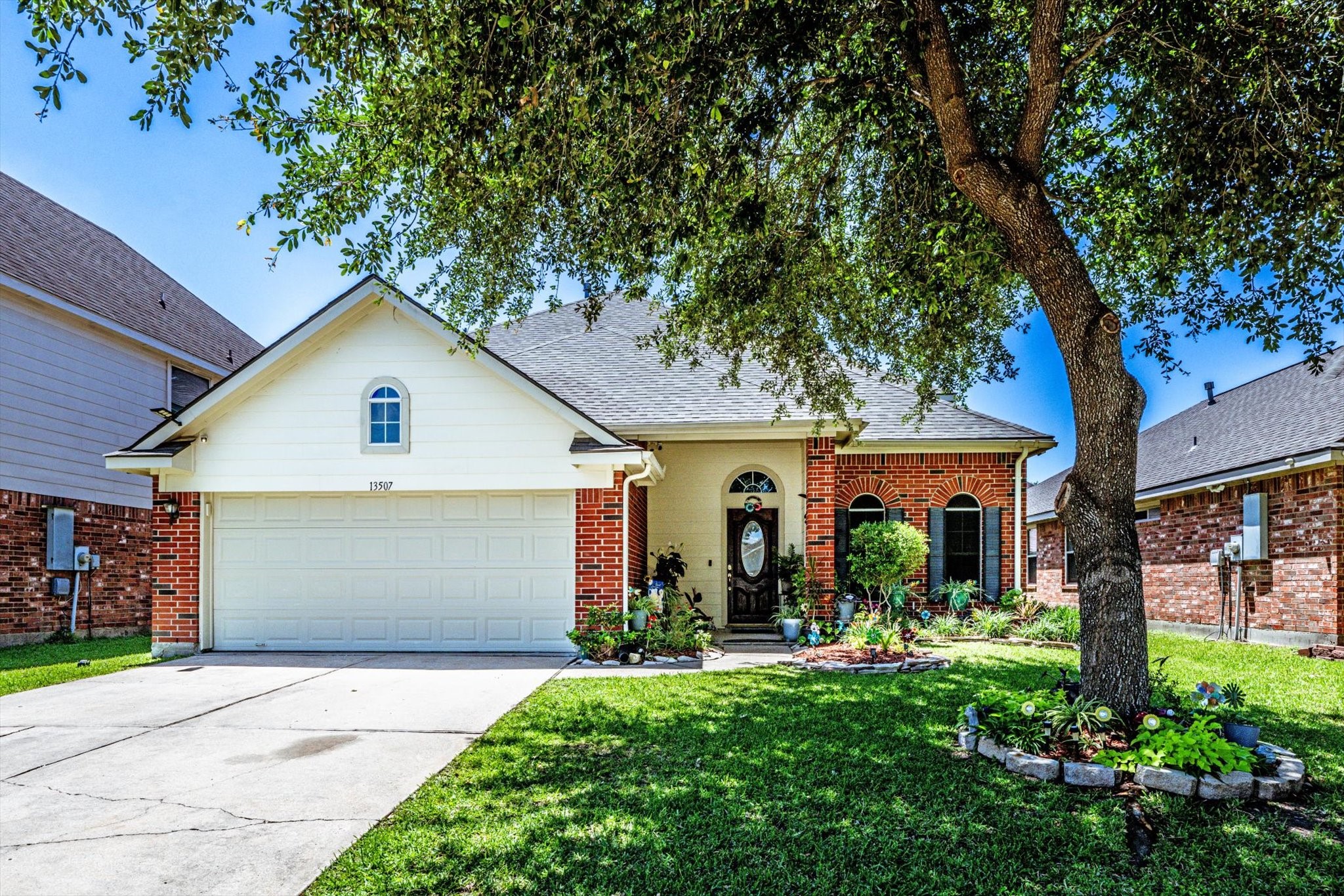 13507 Beech Ridge Lane Houston, TX 77083 - Photo 46 of 49 a view of a white house with a large tree and a yard