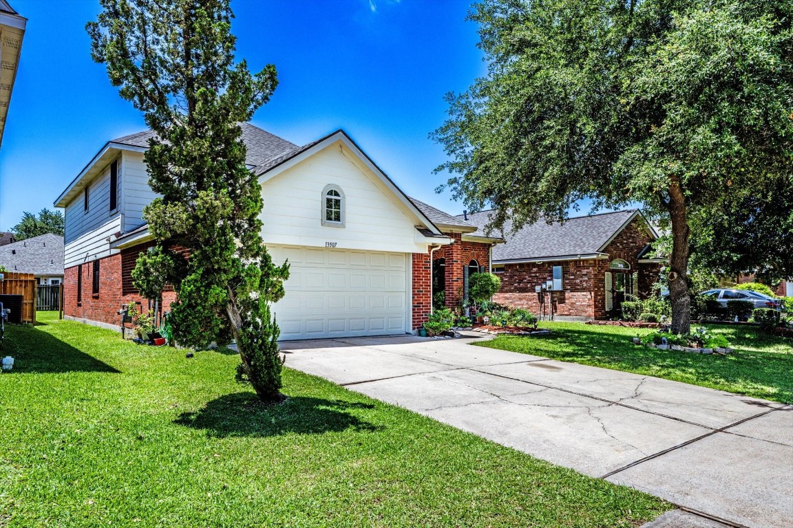 13507 Beech Ridge Lane Houston, TX 77083 - Photo 48 of 49 a front view of a house with a yard and garage