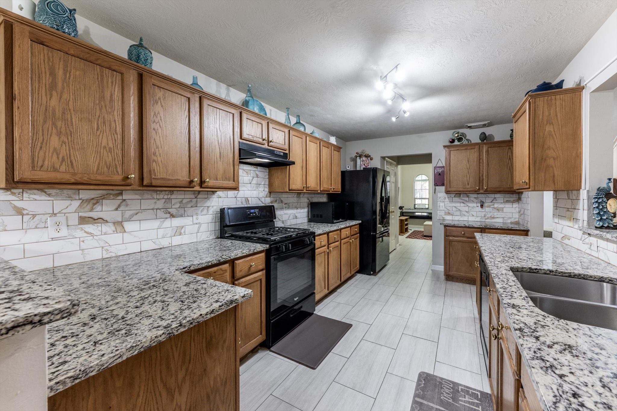 13507 Beech Ridge Lane Houston, TX 77083 - Photo 5 of 49 a kitchen with stainless steel appliances granite countertop a stove sink and cabinets