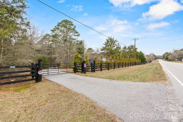 a view of a yard with wooden fence