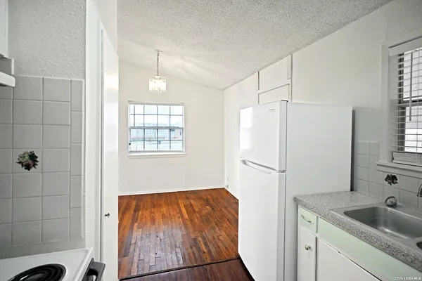a white refrigerator freezer sitting inside of a kitchen