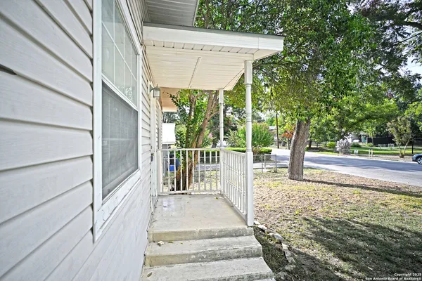 a view of a pathway of a house with wooden floor and fence