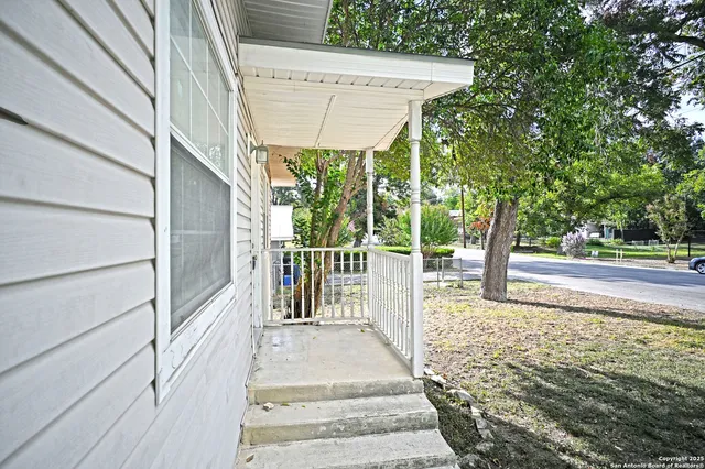 a view of a pathway of a house with wooden floor and fence