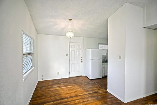 a view of empty room with a fireplace