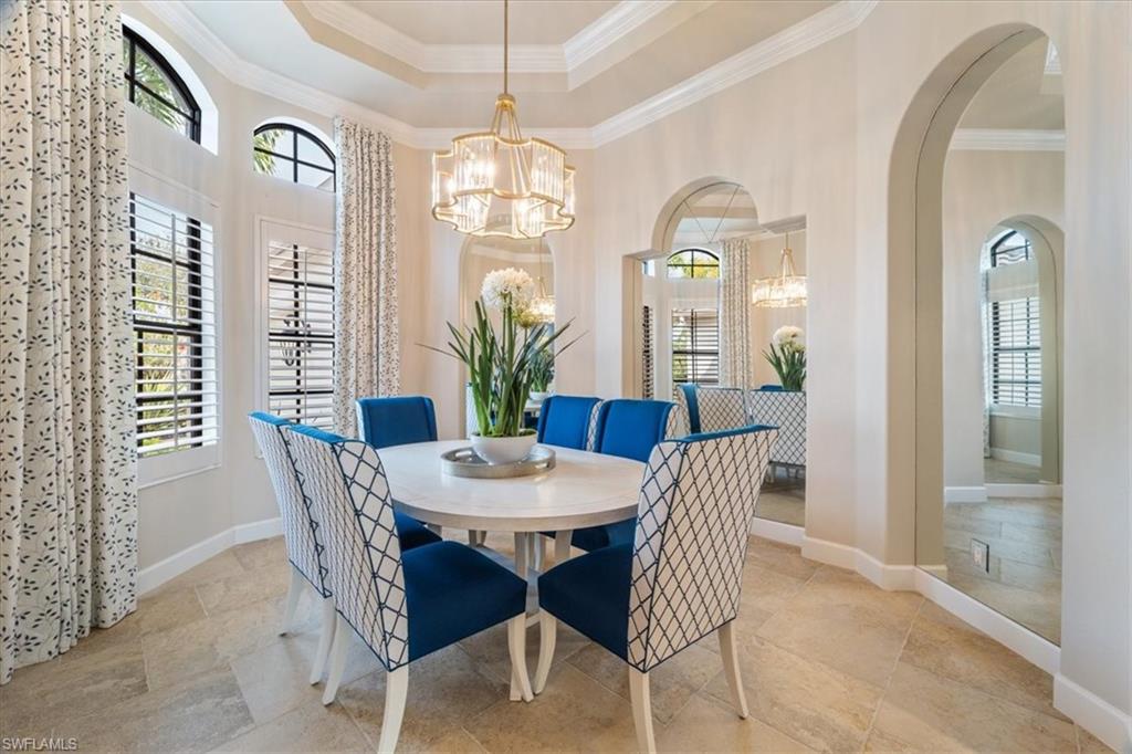 12130 Wicklow Lane Naples, FL 34120 - Photo 11 of 45 a view of a dining room with furniture and chandelier