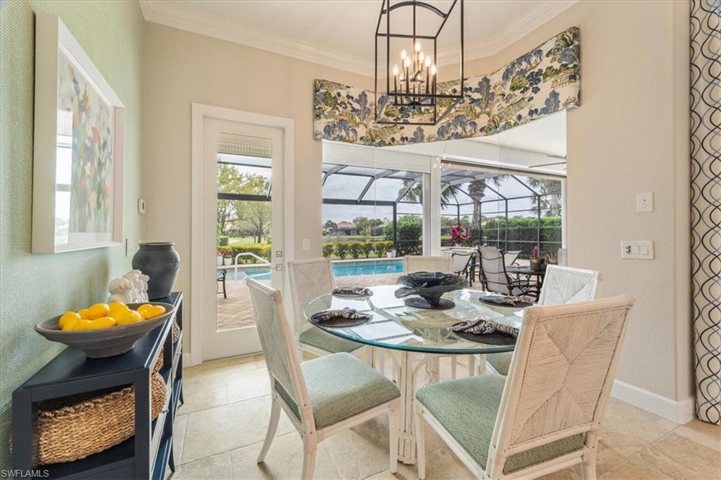 12130 Wicklow Lane Naples, FL 34120 - Photo 16 of 45 a view of a dining room with furniture a chandelier and large windows