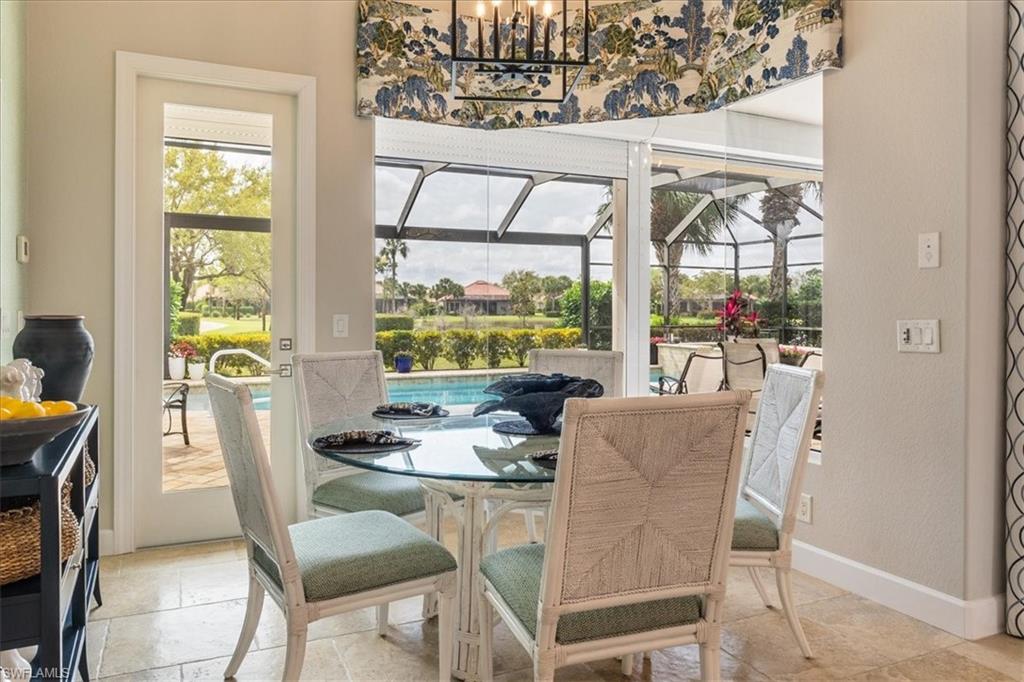 12130 Wicklow Lane Naples, FL 34120 - Photo 17 of 45 a dining room with furniture a chandelier and wooden floor