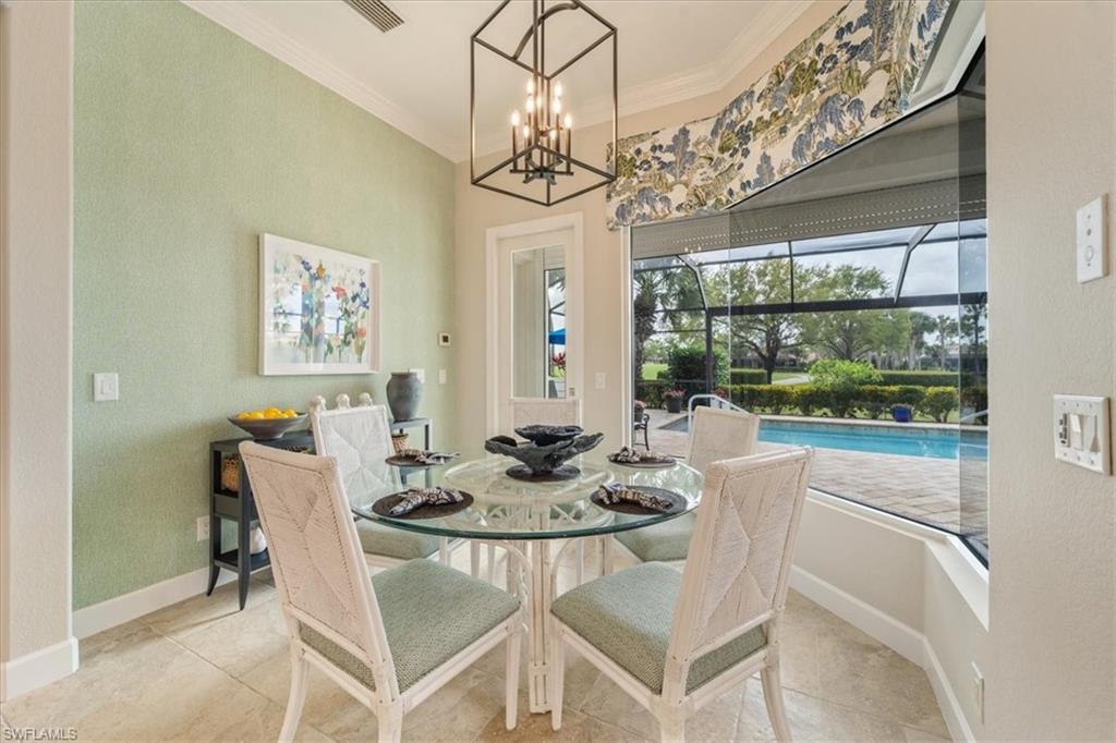 12130 Wicklow Lane Naples, FL 34120 - Photo 18 of 45 a dining room with furniture a chandelier and window