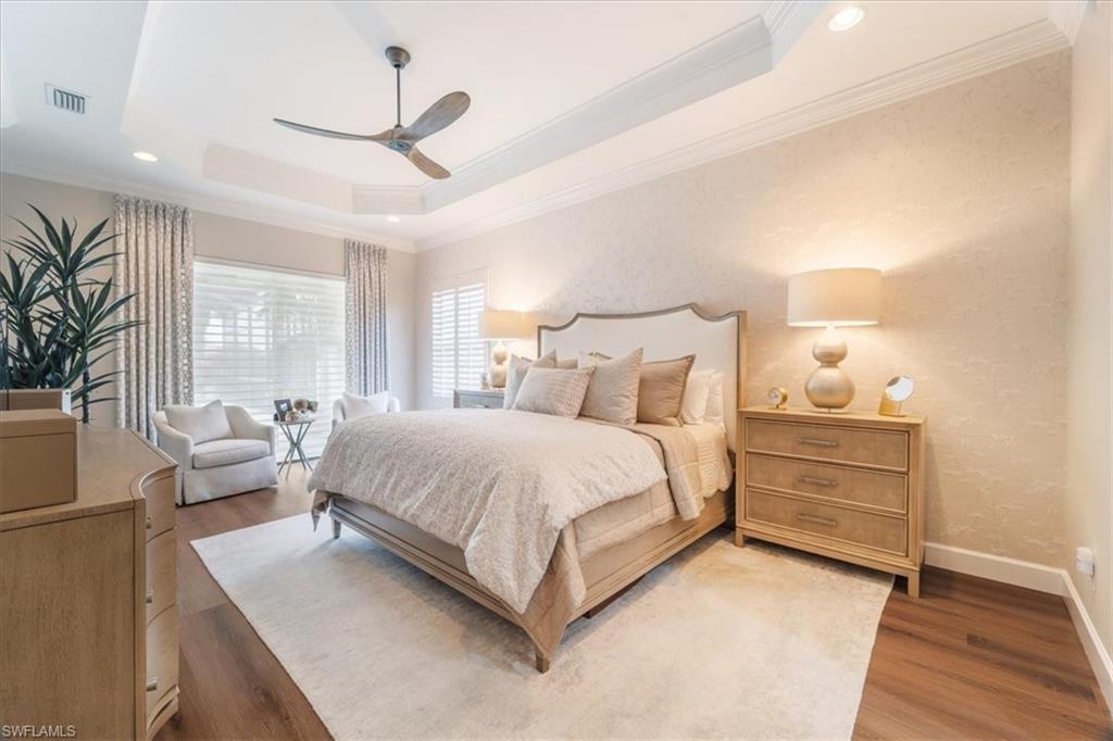 12130 Wicklow Lane Naples, FL 34120 - Photo 19 of 45 a bedroom with a bed and large window