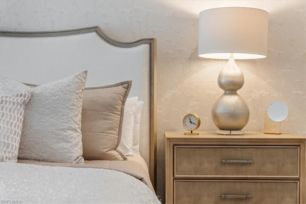 12130 Wicklow Lane Naples, FL 34120 - Photo 21 of 45 a bedroom with a bed and a chandelier