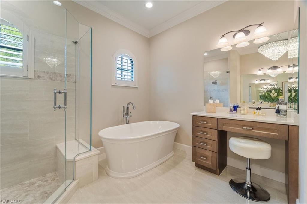 12130 Wicklow Lane Naples, FL 34120 - Photo 23 of 45 a spacious bathroom with a toilet sink and mirror