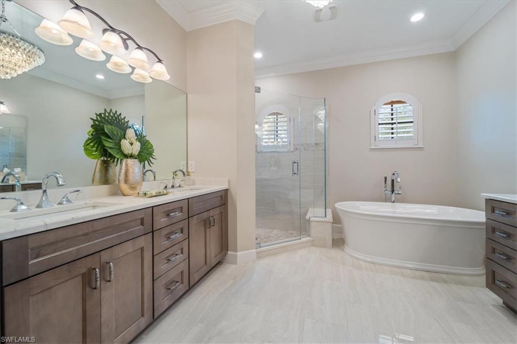 12130 Wicklow Lane Naples, FL 34120 - Photo 24 of 45 a spacious bathroom with a double vanity sink mirror and a bathtub