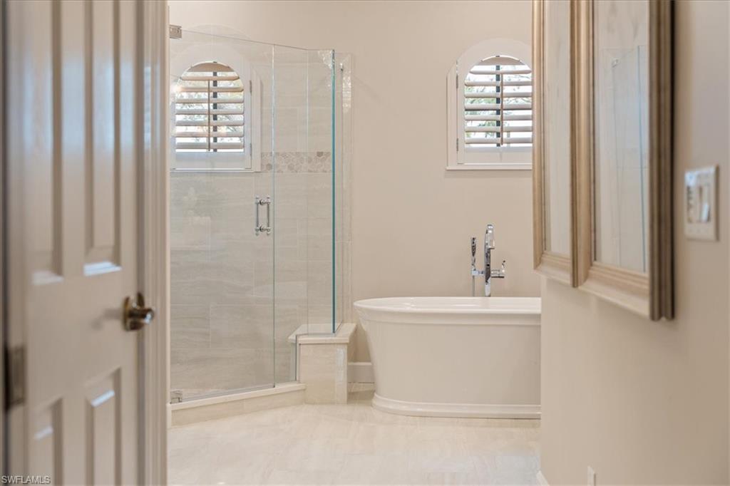 12130 Wicklow Lane Naples, FL 34120 - Photo 25 of 45 a bathroom with a sink a toilet and shower